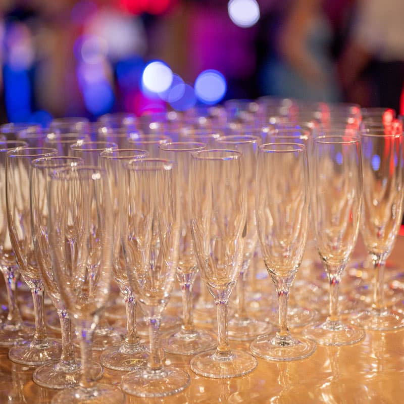 Rangées de flûtes à champagne sur un comptoir lors d'une soirée